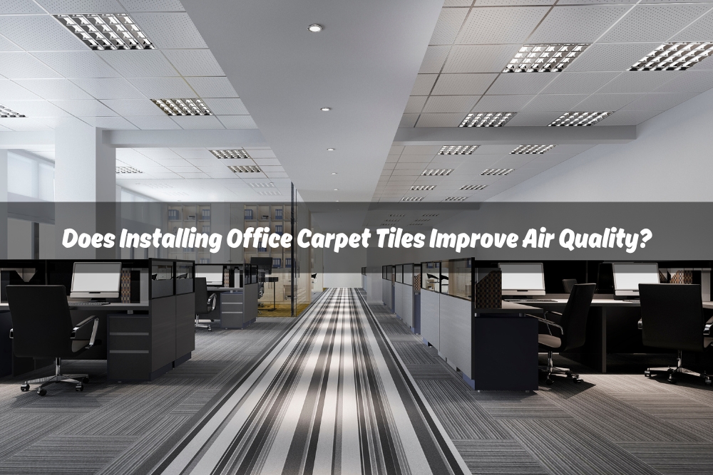 A photo of a textured, gray office carpet tile with a waffle pattern. With a white text overlay "Does Installing Office Carpet Tiles Improve Air Quality?"
