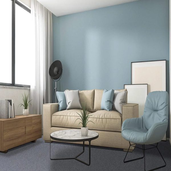 A modern living room with a beige sofa, a light blue chair, a marble coffee table, and a soft carpet.