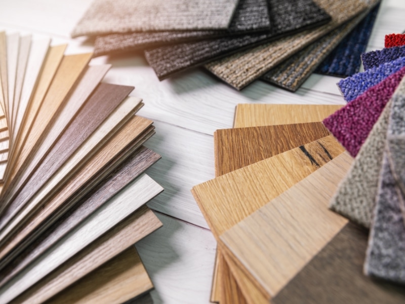Variety of flooring samples including carpet tile design options in multiple textures and colours.