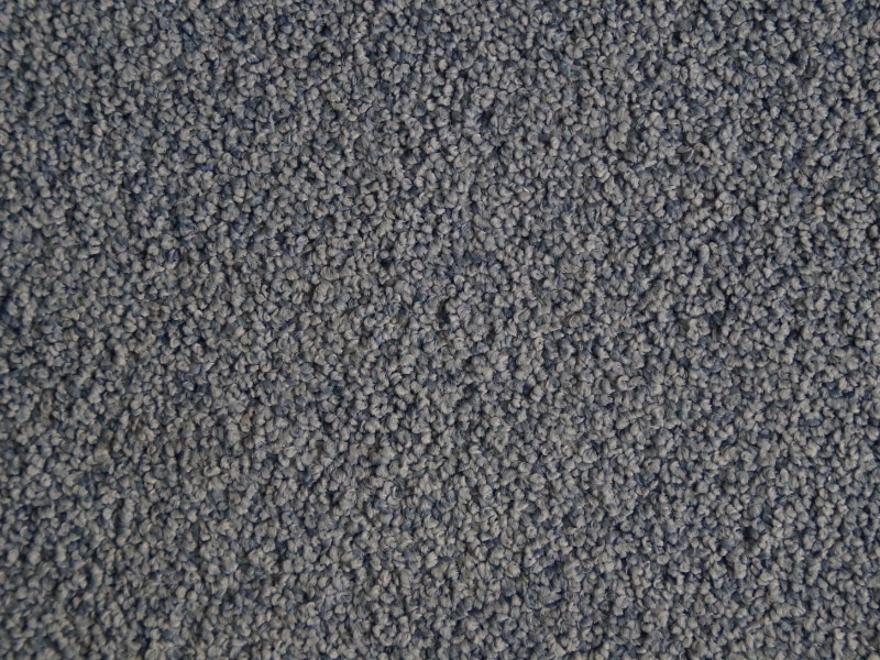Close-up of grey carpet tile design with looped texture for modern interiors